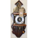 A reproduction walnut and brass Dutch wall clock, having two brass teardrop weights