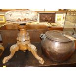 A 19th century copper and iron swing handled cauldron and cover; together with a Victorian music