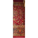 A Persian Kashan red ground woollen rug, 310 x 220cm