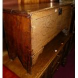 An 18th century provincial boarded oak six-plank coffer, having later floral line carved