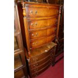 A pair of contemporary mahogany bowfront chests, of four long drawers, each with turned and reeded