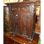 A small 19th century provincial French joined and floral relief carved oak double door side