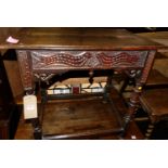 An antique joined and relief carved oak rectangular side table, raised on turned and square cut