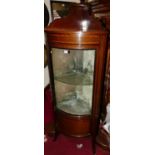 An Edwardian mahogany and satinwood inlaid bowfront single door glazed corner cabinet, with velvet