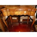 An early Georgian style figured walnut and crossbanded baize lined fold-over card table, having