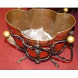 An Arts & Crafts black painted wrought iron and copper inset swing handled coal bucket, of lobed