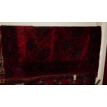 A Persian woollen red ground Bokhara rug, 140 x 140cm Condition report: Long tear to central area of