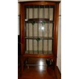 An Edwardian mahogany and leaded glass single door bowfront ledgeback china display cabinet, w.61.