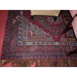 A large Persian woollen red and blue ground Shiraz rug, having geometric floral central ground