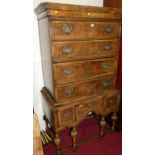 A figured walnut and crossbanded chest on stand in the William & Mary style, the four drawer upper