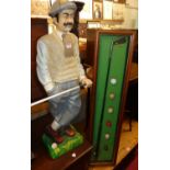 A composite model of a standing golfer, h.92cm; together with a framed display containing golf