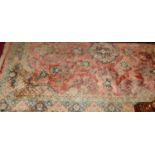 A Persian style machine woven pink ground rug, 265 x 186cm