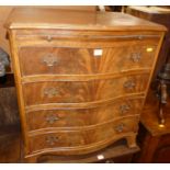 A reproduction mahogany and flame mahogany serpentine front chest, of four long drawers, having