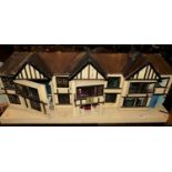 A mock Tudor two-storey dolls house, having hinged compartments and small quantity of dolls house