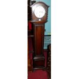 An early 20th century oak grandmother clock, having circular silvered dial, striking and chiming