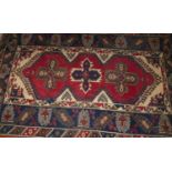 A Persian woollen red and blue ground Shiraz rug, having kilim flatweave ends, 200 x 120cm