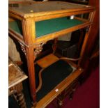 A circa 1900 oak and glazed hinge topped bijouterie table, raised on fluted square supports united