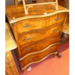 A figured walnut and crossbanded serpentine front chest on stand, having four long drawers and on