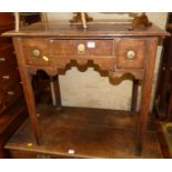 An 18th century provincial oak three drawer lowboy, with shaped apron and on chamfered square