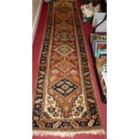 A Persian woollen brown ground Shiraz hall runner, 330 x 80cm