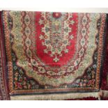 A Persian style machine woven red ground rug, 150 x 90cm