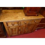 A 19th century French provincial stained pine round cornered dresser base, having two frieze drawers