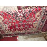 A Persian woollen red ground Shiraz rug, 185 x 128cm