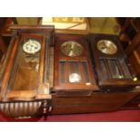 Two near-matching 1930s oak droptrunk wall clocks; together with an early 20th century walnut Vienna