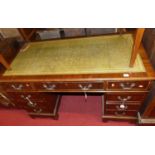 A reproduction mahogany and gilt tooled green leather inset twin pedestal writing desk, w.122cm