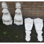 A set of four white painted floral decorated plaster decorative wall brackets, h.59cm