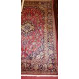 A Persian Kashan red ground woollen rug, 200 x 132cm