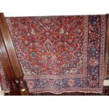 A Persian woollen red ground Tabriz rug, 195 x 132cmCondition report: Colour is good.Some fraying to