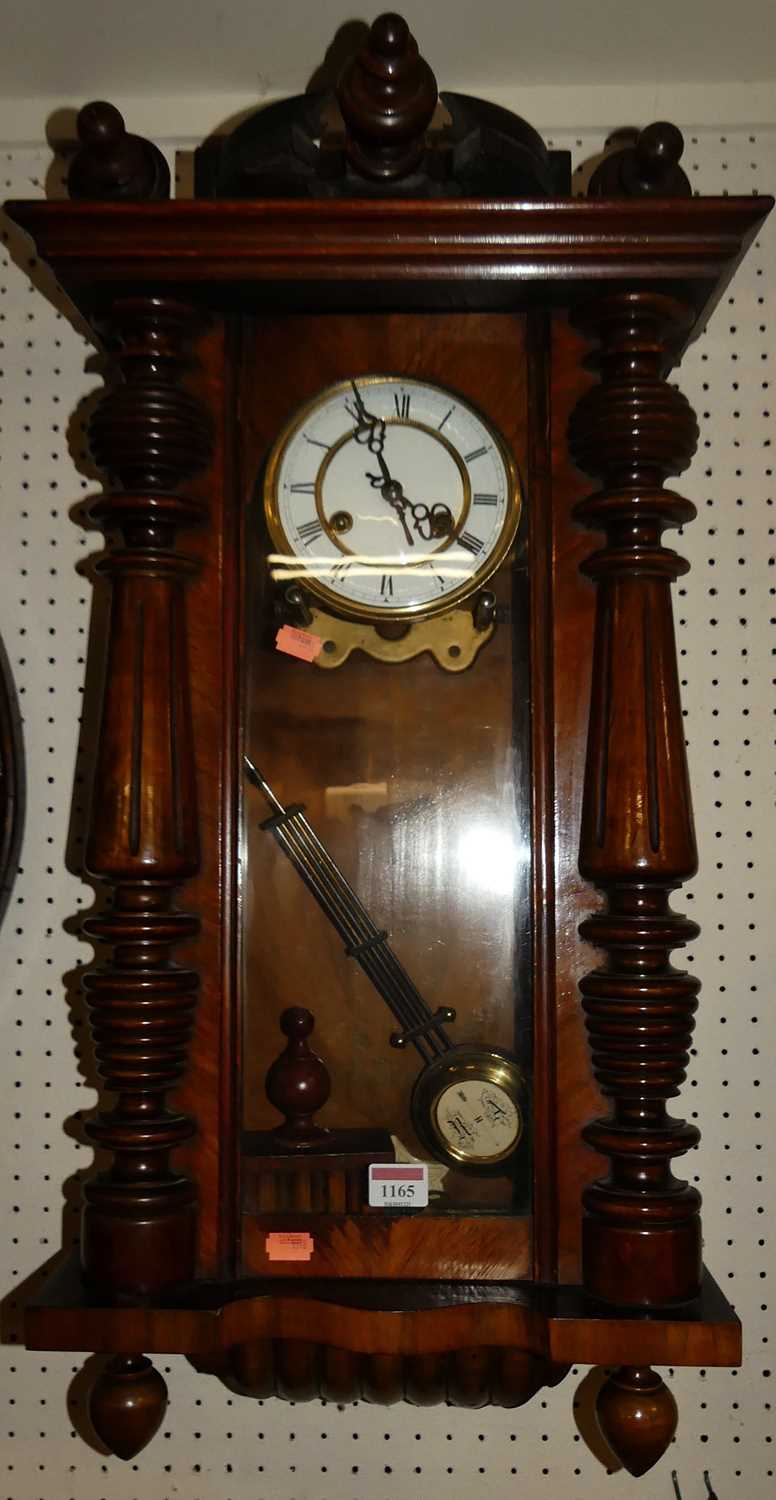 An early 20th century walnut Vienna droptrunk wall clock