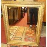 A late 19th century floral gesso decorated rectangular wall mirror, having a later inset mirrorplate