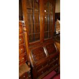 An early 20th century geometric moulded oak bureau bookcase, w.80cm