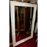 A contemporary French style white painted and floral decorated bevelled rectangular floor mirror,