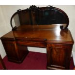 A mid-Victorian mahogany mirrorback twin pedestal inverted breakfront sideboard, having single