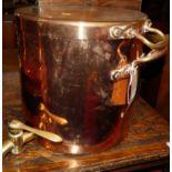 A large circa 1900 copper twin handled water bowser and cover, with fitted brass levered tap, dia.