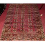 A Persian woollen red ground Bokhara rug (fading to surface), 140 x 108cm