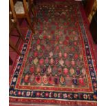 A Persian woollen Bokhara rug, the central repeating ground within trailing tramline borders, 270