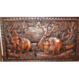 A modern Far Eastern carved hardwood panel, depicting elephants, 44 x 76cm