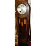 A 1930s oak long case clock, having a glazed trunk door, with three train movement (with pendulum