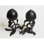 A pair of bronze jars and covers, each in the form of a piece of fruit on scrolling leaf support,