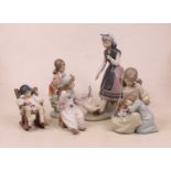 A collection of five Lladro Spanish porcelain figures, to include girl with geese at her feet, two