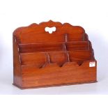 A mid-19th century mahogany letter rack, having carved sebka decoration above three tiered