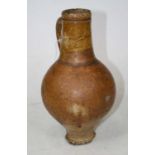 An 18th century(?) stoneware bellarmine, having typical tapering neck and loop handle to a bulbous
