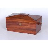 A Regency mahogany tea caddy, of sarcophagus form, having inlaid brass escutcheon and flanked by