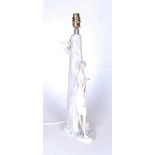 A Lladro porcelain table lamp in the form of a young woman leaning against a tree, h.51cm