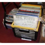 Two boxes of singles and LPs, to include Neil Young, Eric Clapton, The Grease soundtrack, Meatloaf