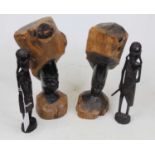 A pair of African hardwood busts, each carved in the round as a face, h.29cm; together with